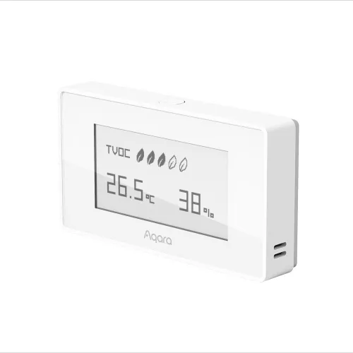 Na zdjęciu znajduje się biały, prostokątny czujnik Aqara z wyświetlaczem pokazującym temperaturę 26,5°C i wilgotność 38%. Urządzenie ma minimalistyczny design i wyświetla również wskaźnik TVOC.
