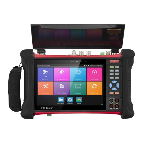 Wielofunkcyjny tester CCTV z kolorowym ekranem dotykowym i różnorodnymi przyciskami funkcyjnymi na bokach. Urządzenie posiada uchwyt po lewej stronie i kilka portów na górze, a jego obudowa jest w kolorze czarno-czerwonym.
