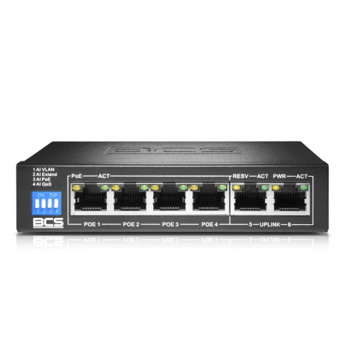 Na zdjęciu znajduje się czarny switch sieciowy BCS z sześcioma portami Ethernet, z których cztery są oznaczone jako PoE. Na przednim panelu widoczne są również diody LED sygnalizujące aktywność oraz przełączniki DIP do konfiguracji urządzenia.